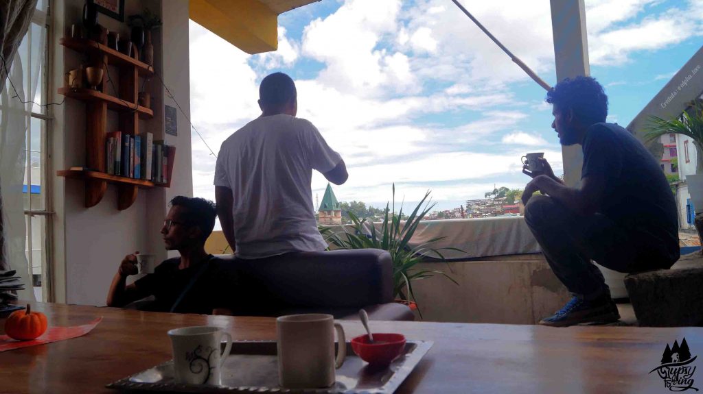 Joydeep The Gypsy Chiring and his friends in Kohima hostel watching the morning view of the town.