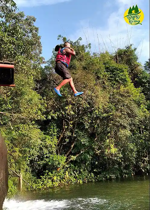 a person jumping from a cliff in mawlyngbna meghalaya