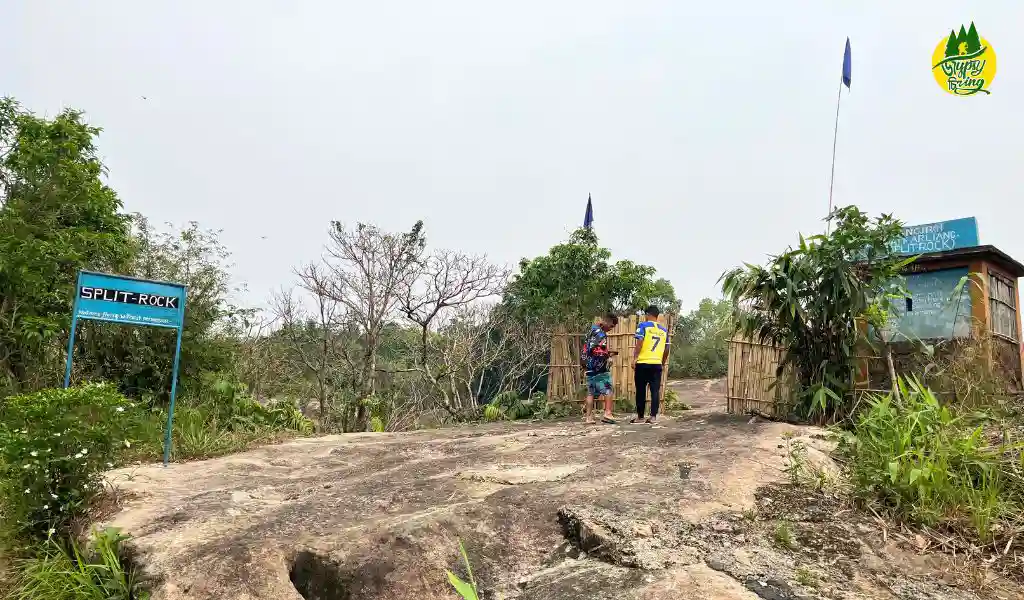 two people standing on a the entrance of mawlyngbna rock split area