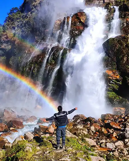 a person standing infront of Nuranang Falls, Jang Falls Photo in Arunachal Pradesh