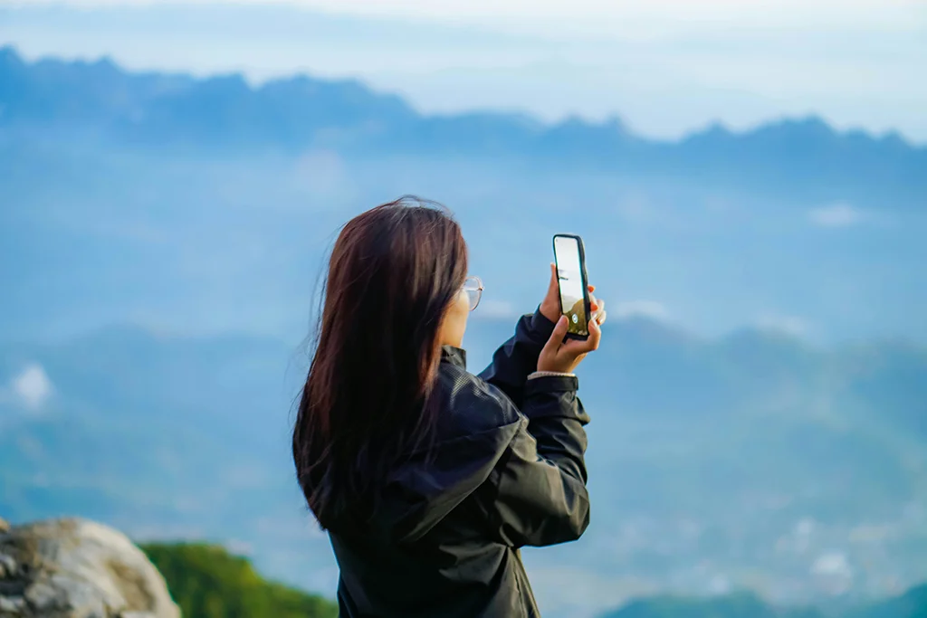 Cost of Always Documenting Travel Experiences - a girl trying to click a picture - Let me get this shot right