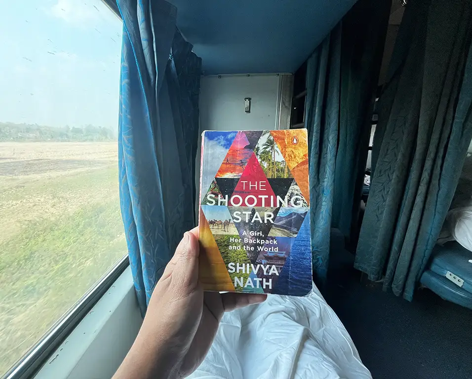 Joydeep the gypsy chiring reading a book in AC Three Tier 3A Type of Travel Classes in Indian Railways