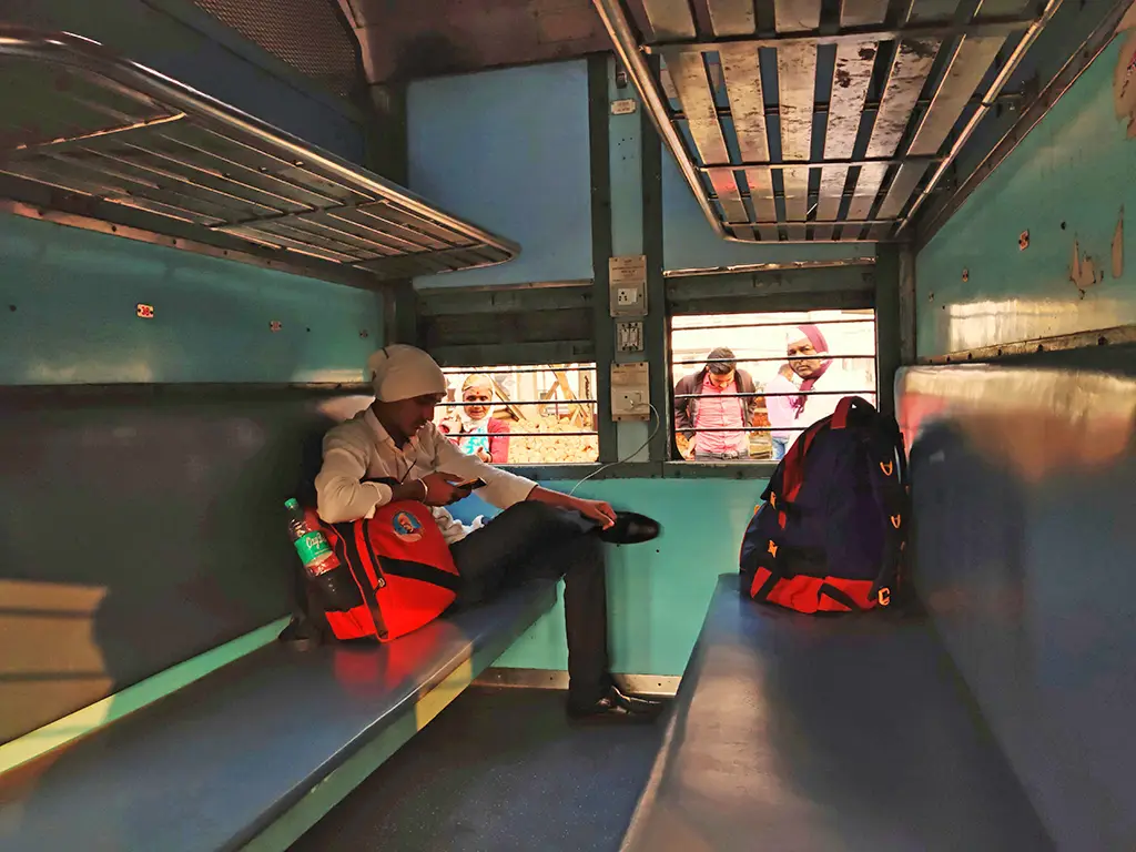 A man sitting in an Unreserved General Class Coaches in Indian Railways