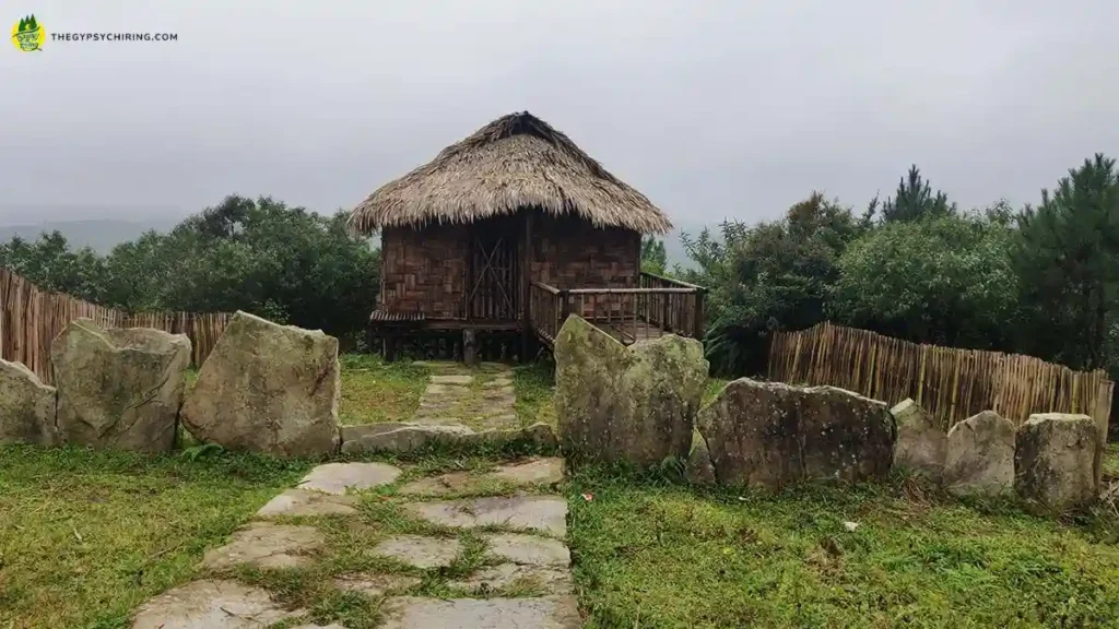 A traditional Khasi House with monoliths as border stone in Khasi Heritage Village Mawphlang Shillong Meghalaya - The Gypsy Chiring