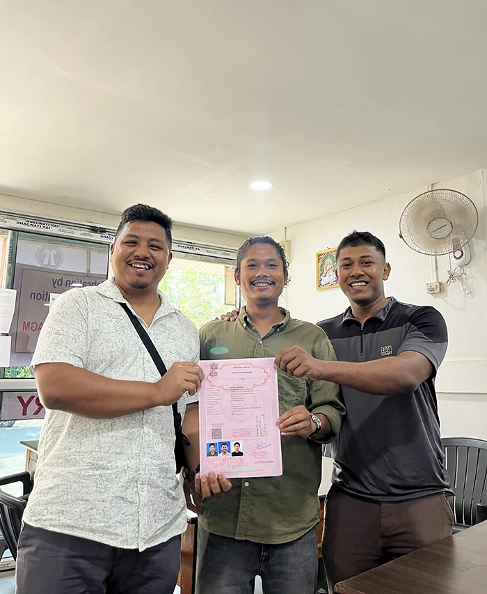 Joydeep The Gypsy Chiring, Gitartha and Subradip - co founders of Tales of Northeast holding the registration agreement of their travel company
