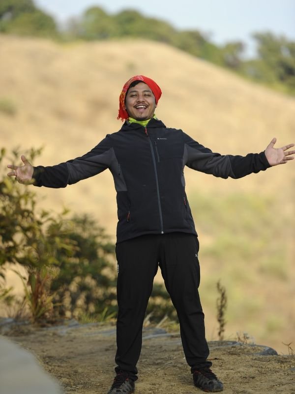 Joydeep The Gypsy Chiring widening his arms at the top of Mount Kapamodzu Peak in Phek Nagaland